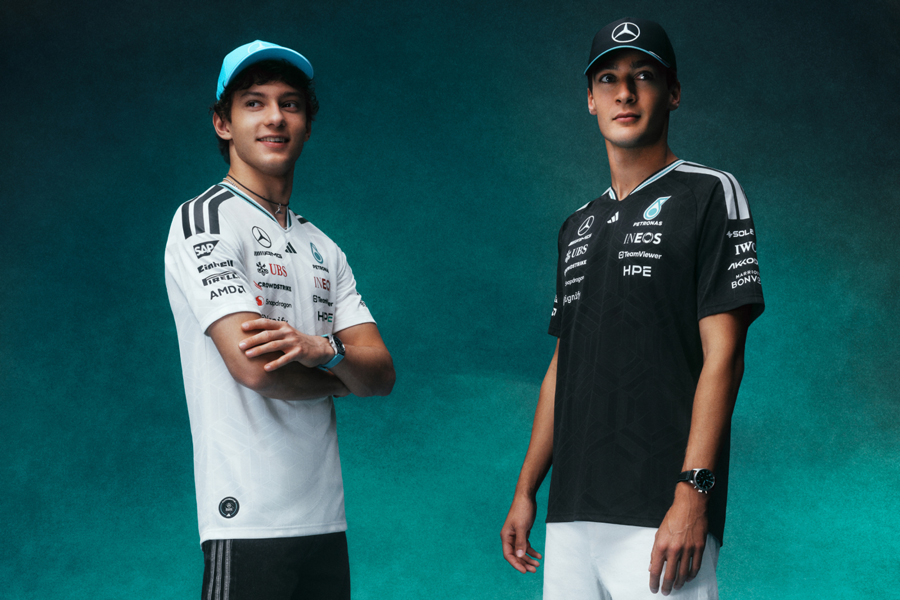zu sehen ist ein Banner der Adidas und das Mercedes-AMG PETRONAS Formula One Team Collection 2026. Verschiedene Models tragen die Team Poloshirts in schwarz und weiß.